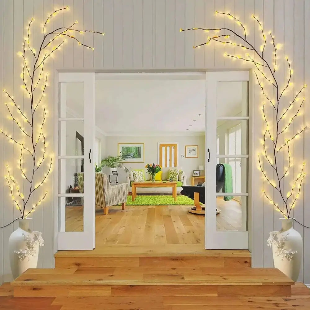 Delicate black branch-shaped enchanting vine lights with warm white LEDs in elegant off-white ceramic vases create a tranquil oasis
