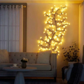 Enchanting vine lights warm yellow led branches arranged on a wall in a tree branch design creating a tranquil oasis