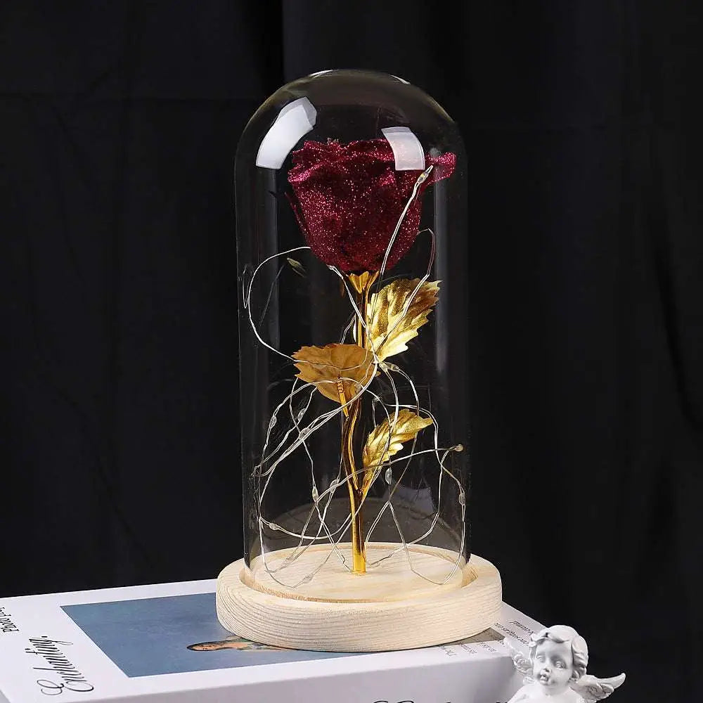 A glittering crimson eternal rose led with golden leaves encased in an elegant glass dome romantic gift set