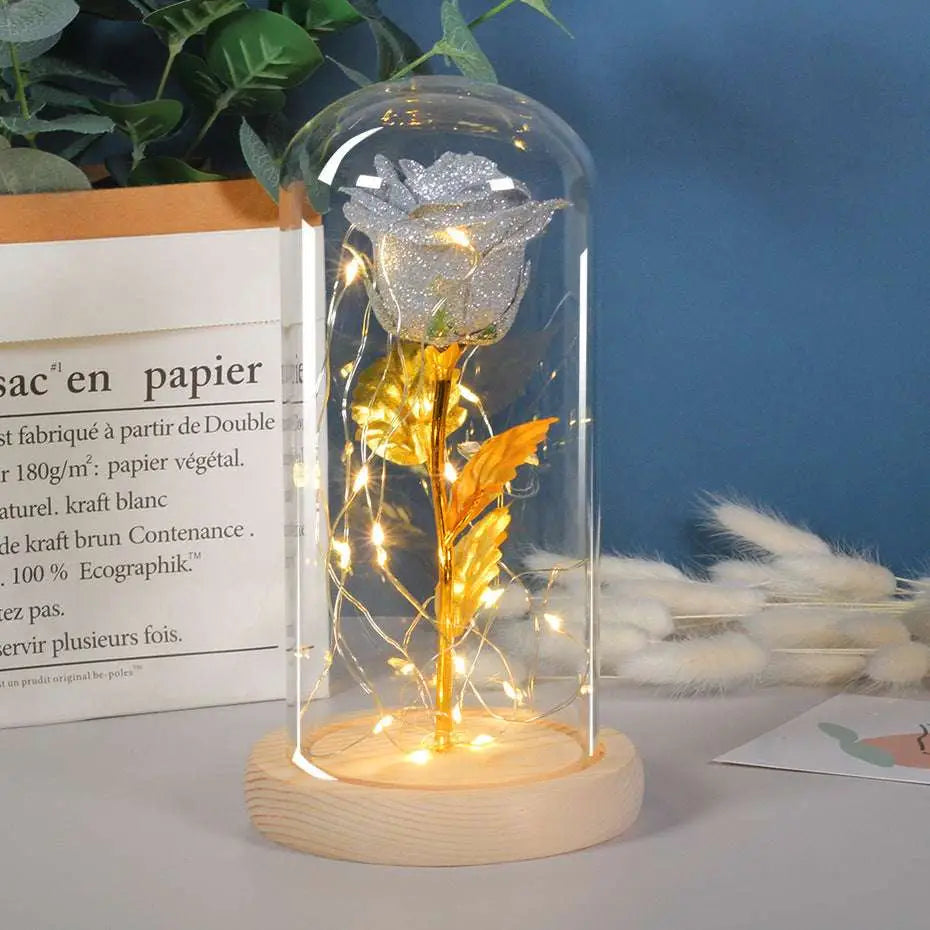 A collection of five eternal rose led illuminated preserved roses with golden stems in elegant glass dome romantic gift