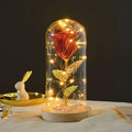 Eternal rose LED light featuring a glittering red rose with gold leaf stem in an elegant glass dome romantic gift