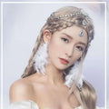 A delicate silver ethnic purple crystal style headwear with sparkling crystals and a blue teardrop pendant in braided hair