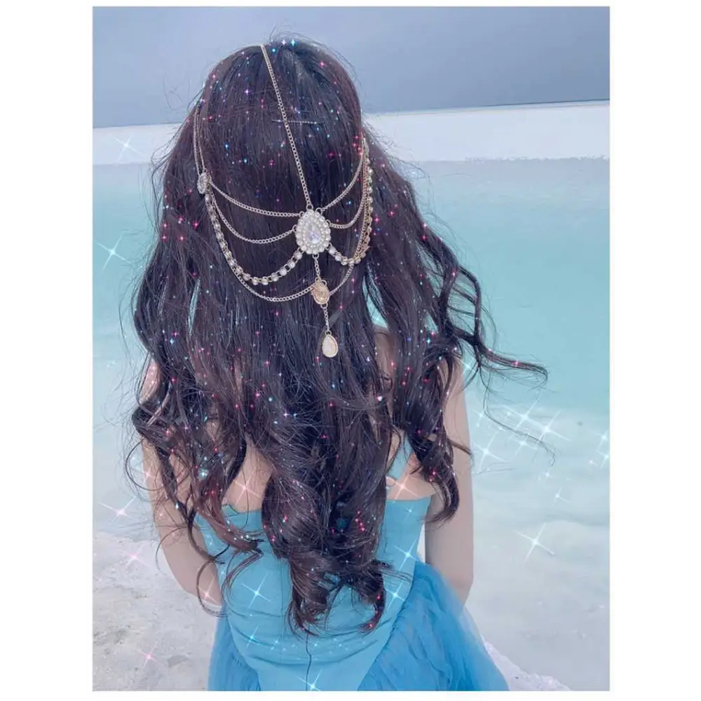 A delicate multi-strand gold-toned ethnic purple crystal style headwear hair accessory with rhinestones and teardrop charms
