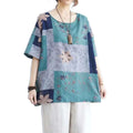 Ethnic style loose round neck floral patchwork blouse with teal and navy blue sections and short sleeves