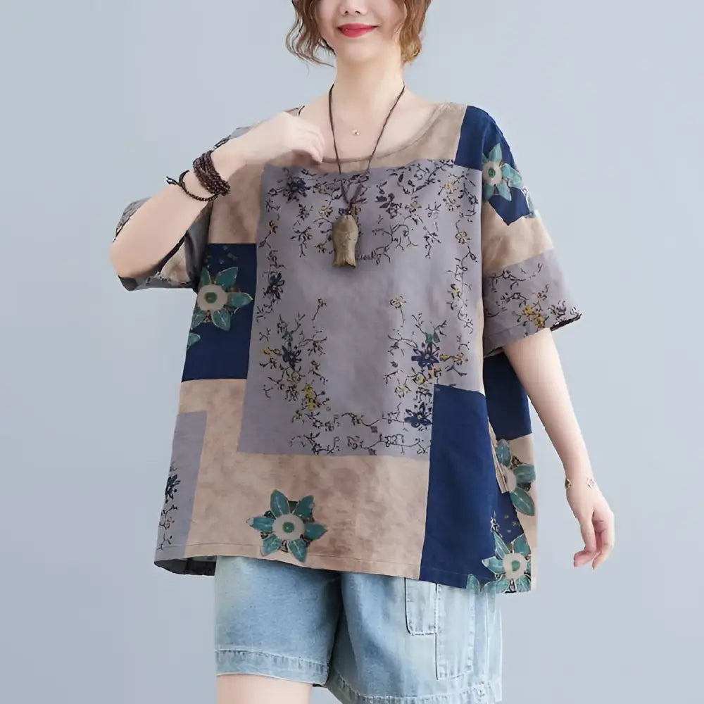 Ethnic style loose round neck floral patchwork blouse in muted blue beige and gray with teal and gold floral panels