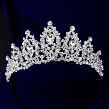 A sparkling silver bridal crown european adorned with clear teardrop crystals and an intricate leaf design