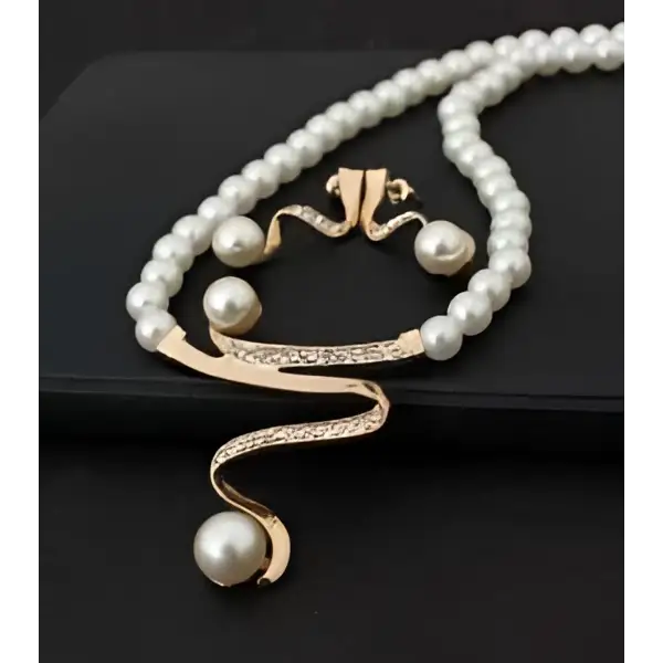 Gold-toned european fashion diamond crystal pearl jewelry set featuring a flowing necklace with rhinestones and white pearls