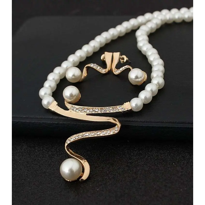 Gold-toned european fashion diamond crystal pearl jewelry set featuring a flowing necklace with rhinestones and white pearls