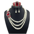 Elegant european fashion diamond gemstone pearl jewelry set featuring a three-strand pearl necklace with red accents and matching silver earrings and bracelet