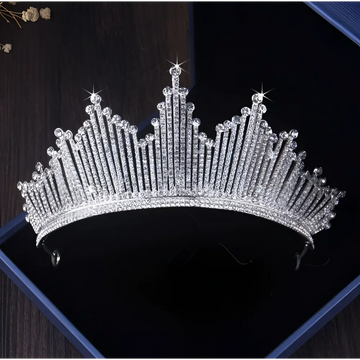 A sparkling silver European style birthday headdress crown adorned with clear crystals in a regal pointed design