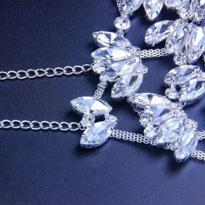 A sparkling silver chain necklace with clear marquise-cut crystals for an exaggerated fashion rhinestone mask