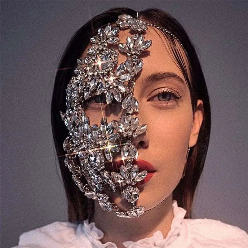 A dazzling silver fashion rhinestone mask with intricate floral designs and sparkling crystals for exaggerated fashion rhinestone style