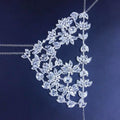 A silver exaggerated fashion rhinestone mask with intricate floral designs featuring cascading leaves and blossoms