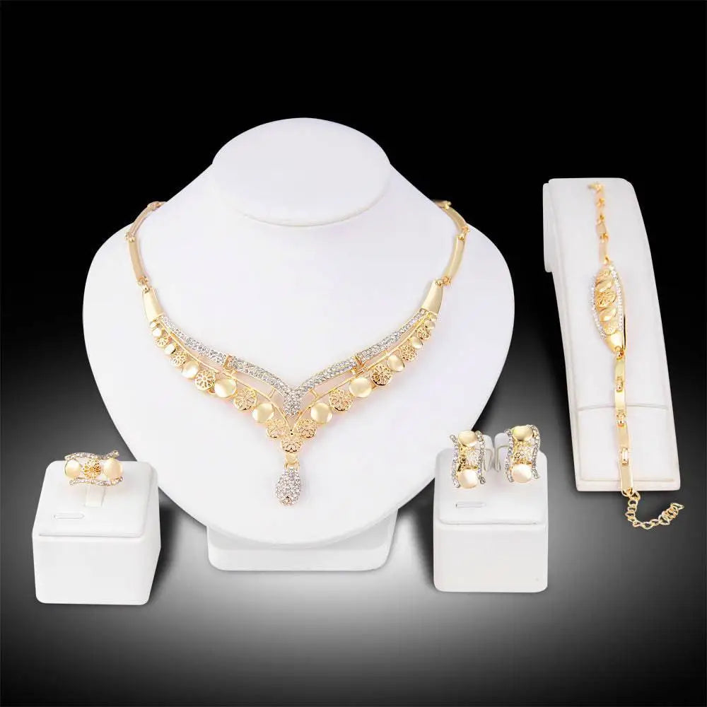 Gold-toned necklace with intricate filigree, rhinestone accents, and teardrop pendant from exaggerated jewelry sets bridal jewelry four