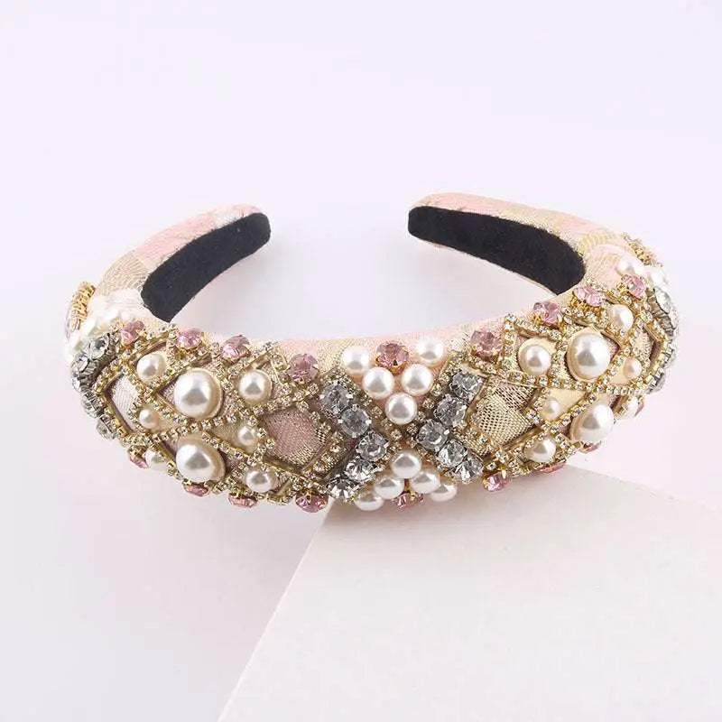 A blush pink sponge baroque headband with padded exaggerated sponge baroque design featuring pearls and rhinestones