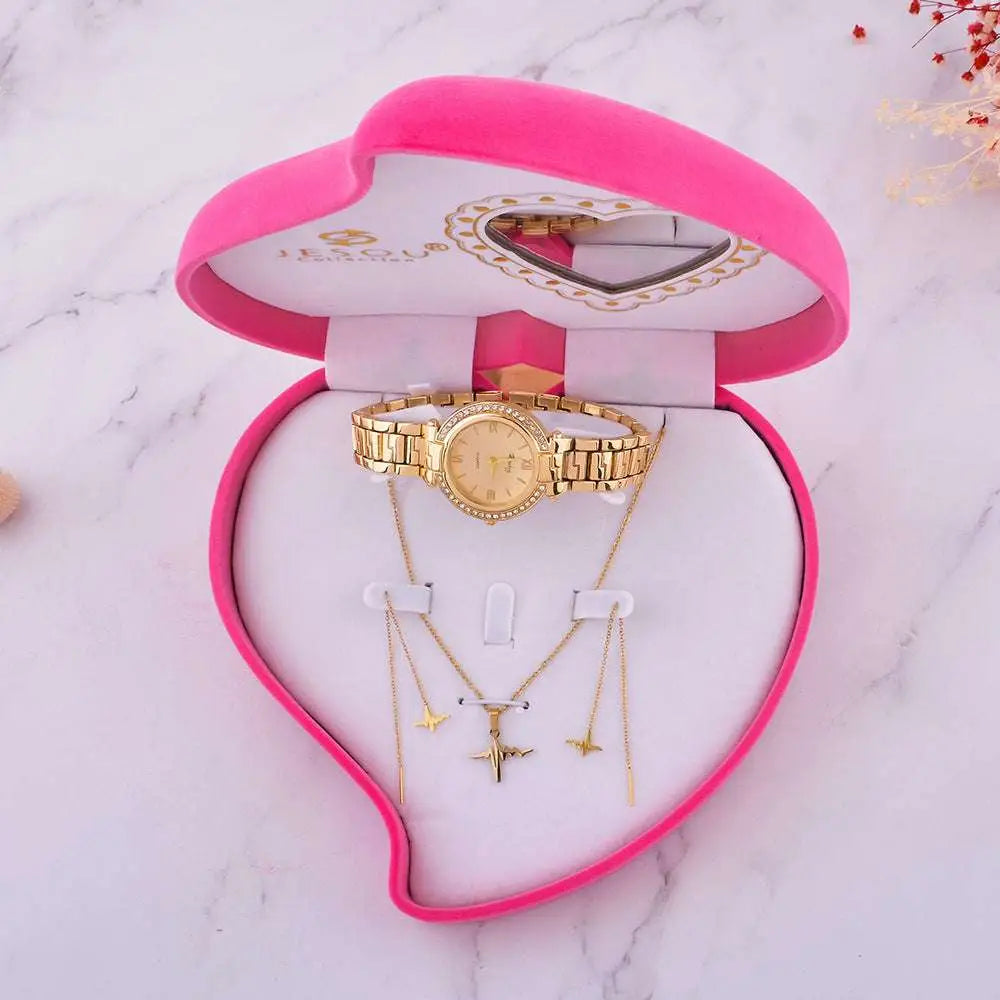 Exquisite jewelry watch with gold-toned diamond bezel and matching airplane pendant necklaces in heart-shaped box