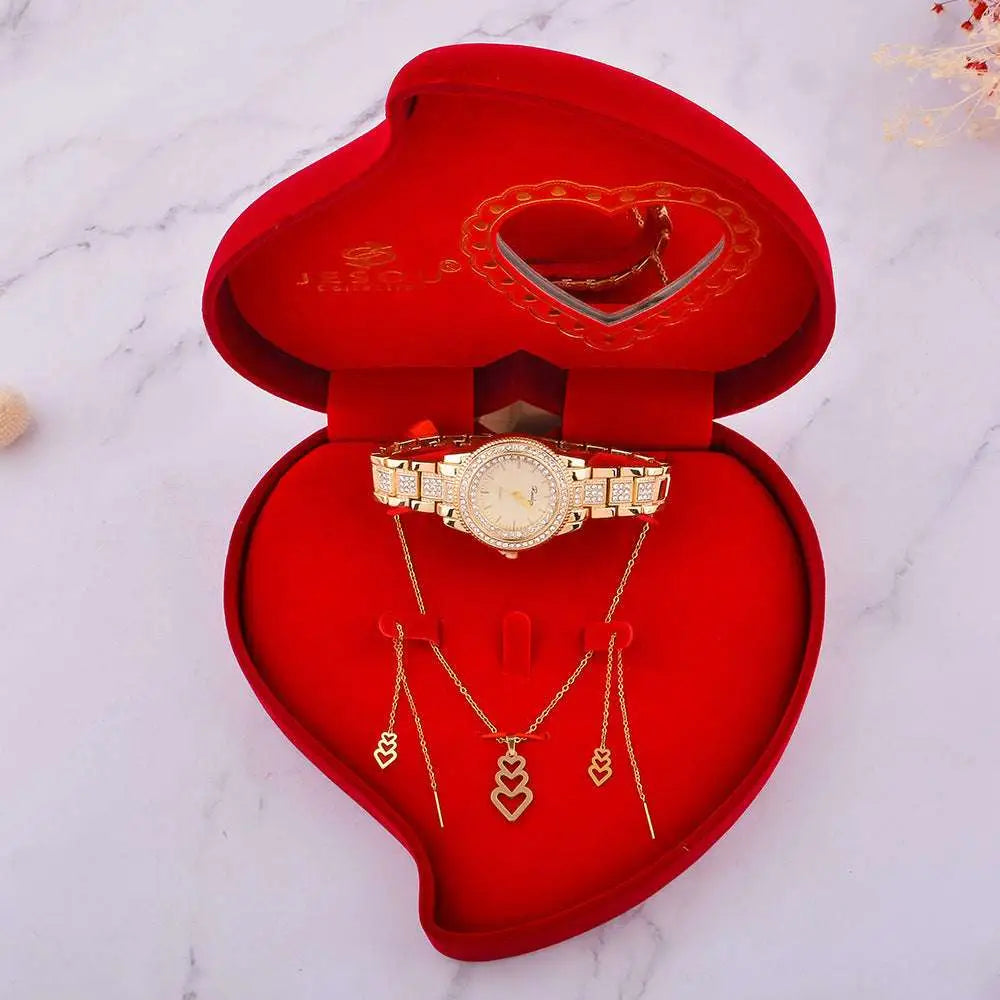 Gold-toned exquisite jewelry watch with diamond-studded bracelet and matching necklaces in a red velvet heart-shaped box