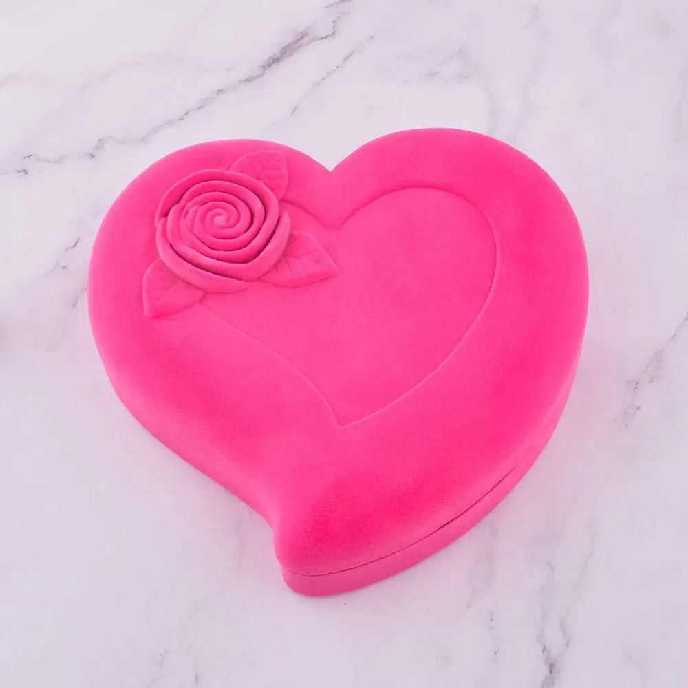 A vibrant pink heart-shaped velvet box with a raised rose detail for exquisite jewelry watch necklace gift
