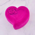 A vibrant fuchsia velvet heart-shaped box with raised rose embellishment for exquisite jewelry watch necklace gift