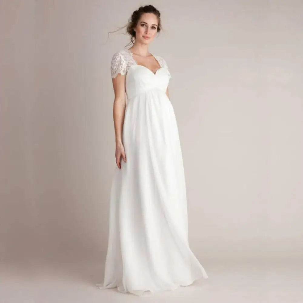 A flowing white wedding gown with delicate lace cap sleeves and eyelashes lace stitching japanese cotton fabric