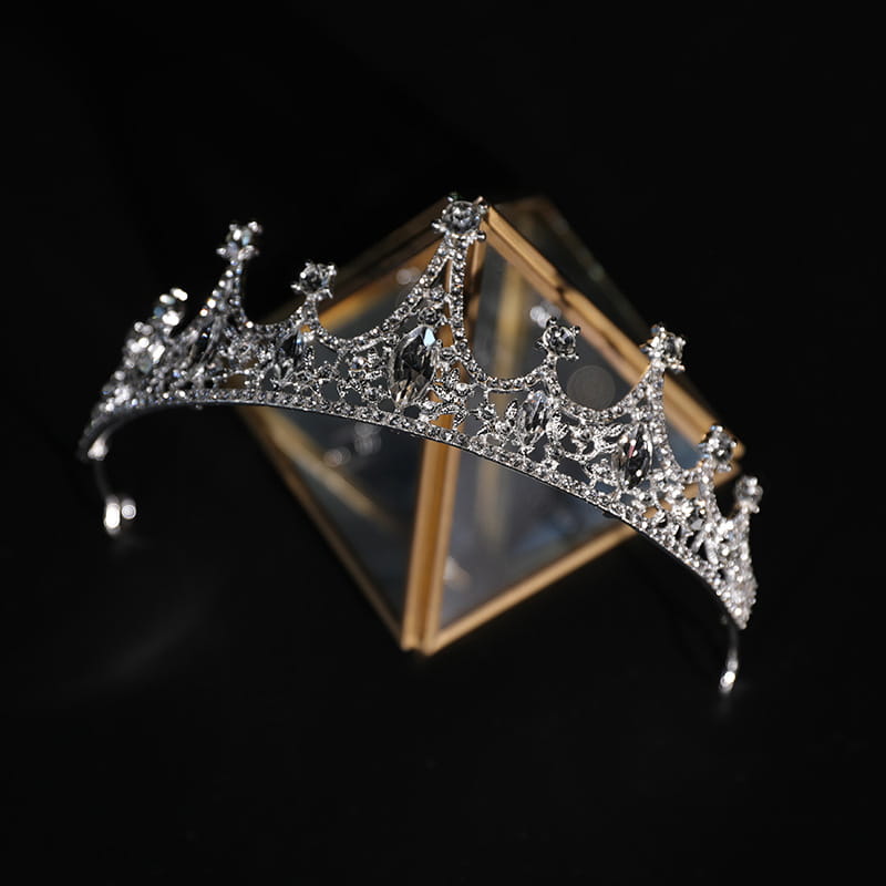 A sparkling silver bridal crown rhinestone tiara featuring intricate crystal embellishments and a central marquise-cut gemstone in baroque style.