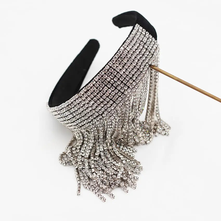 A sparkling silver rhinestone tassel diamond pearl bridal headband with cascading fringe designed as an elegant pearl gift bridal accessory.