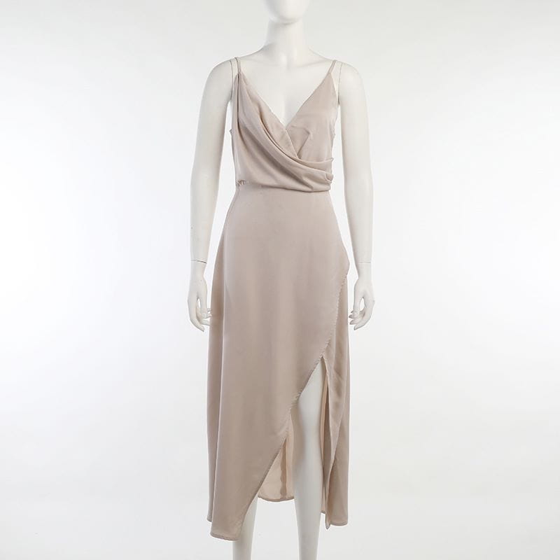 beige satin slip dress with a draped v-neckline and an asymmetrical high slit ideal for dress summer fashion and slit sling dress styling.