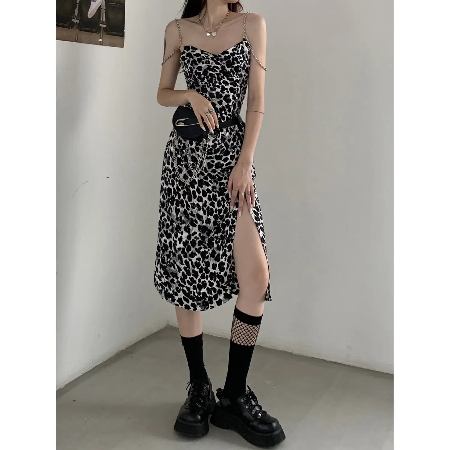 Sexy leopard print chain satin slip dress featuring a black and white leopard print midi length with thin spaghetti straps and a side slit.