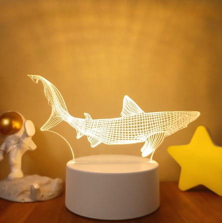 White shark-shaped 3d led night light with a grid pattern and glowing outline featuring colorful touch remote control for adjustable lighting.