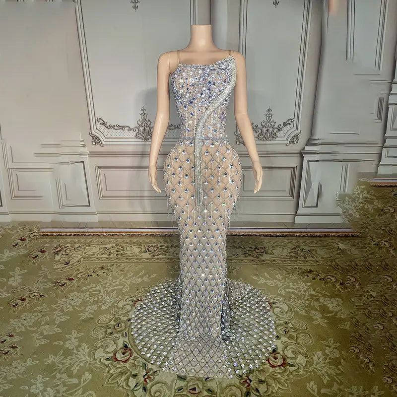 a shimmering silver beaded sexy elegant fishtail gown featuring a sheer diamond-patterned overlay and cascading fringe detailing