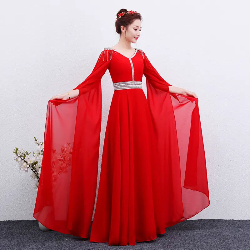 a flowing red satin gown with long sheer sleeves and a silver beaded belt designed as an elegant red long guzheng performance dress
