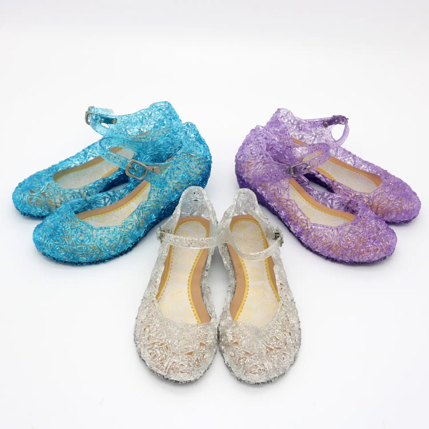 set of three colorful translucent girls crystal shoes with intricate lace-like patterns and metallic buckle details featured as pink rose girls crystal high heel sandals ideal for summer princess shoes.