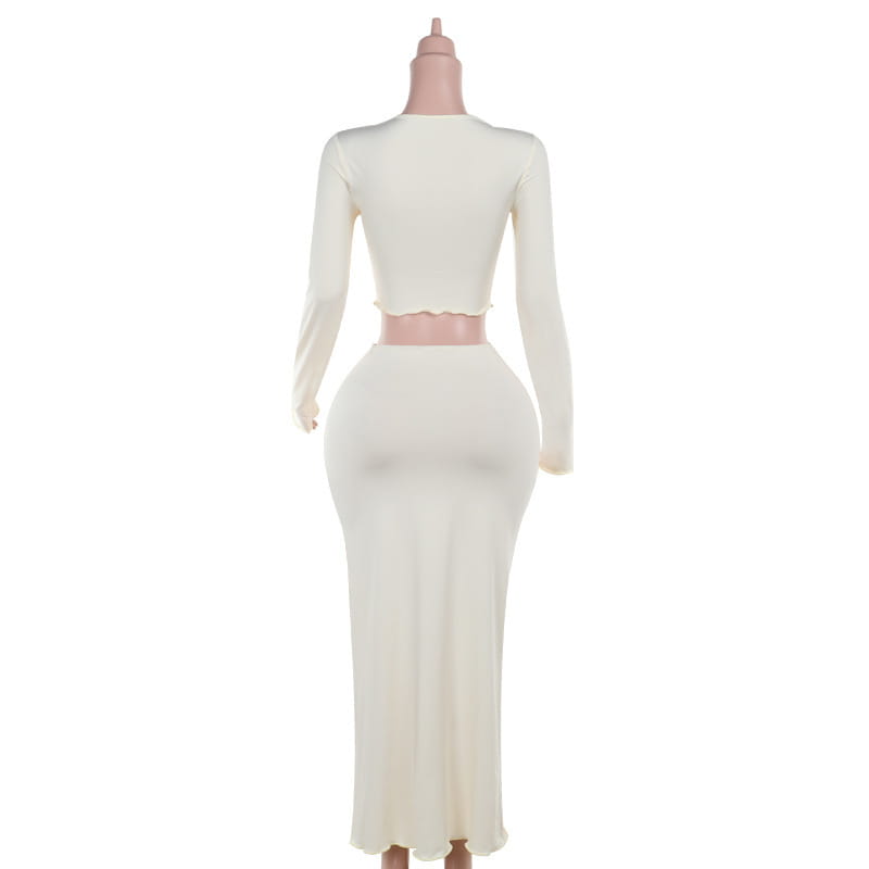 Cream-colored elegant slim print two-piece set featuring a long-sleeved cropped top with scalloped hem and a high-waisted slim print round neck skirt.