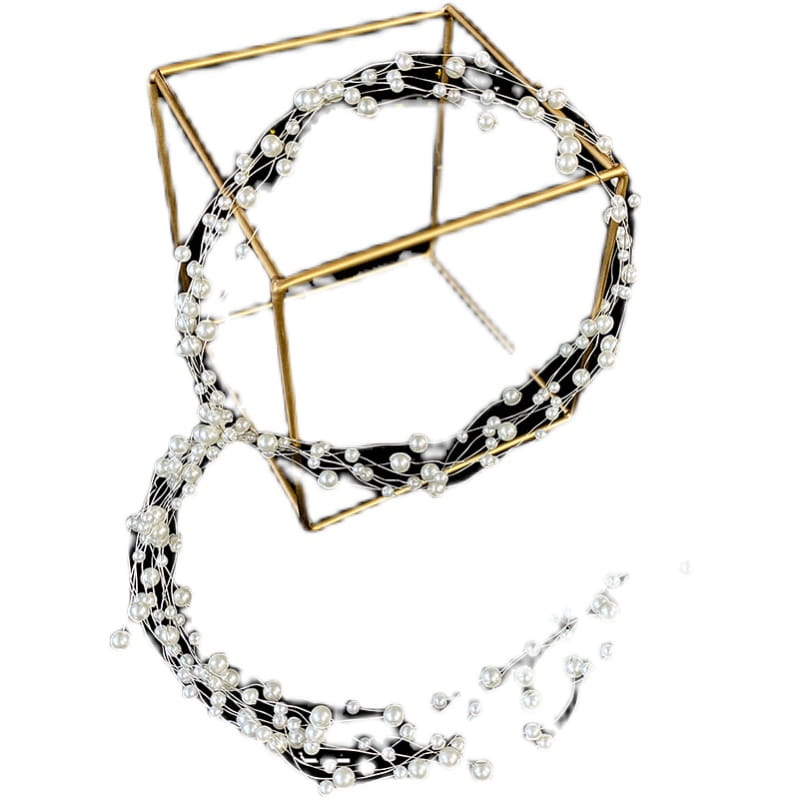 Handmade pearl fairy bridal headdress featuring a gold-toned geometric cube adorned with a cascading strand of white pearls for an elegant bridal look.