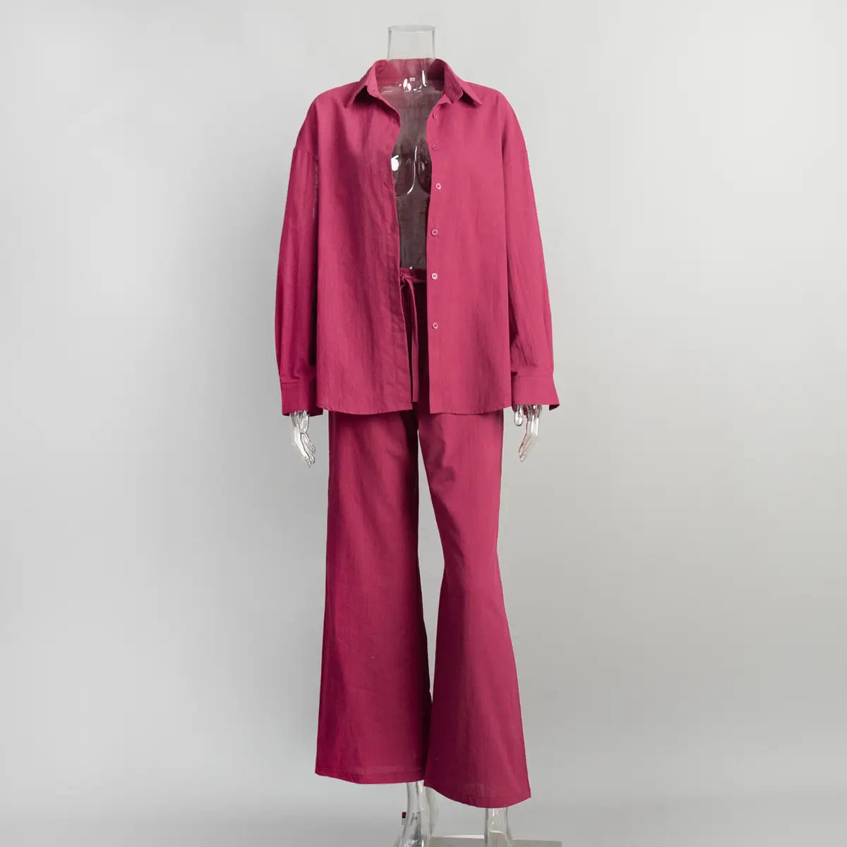 fuchsia-colored cotton shirt trousers suit featuring a long sleeve button-up shirt and flared pants