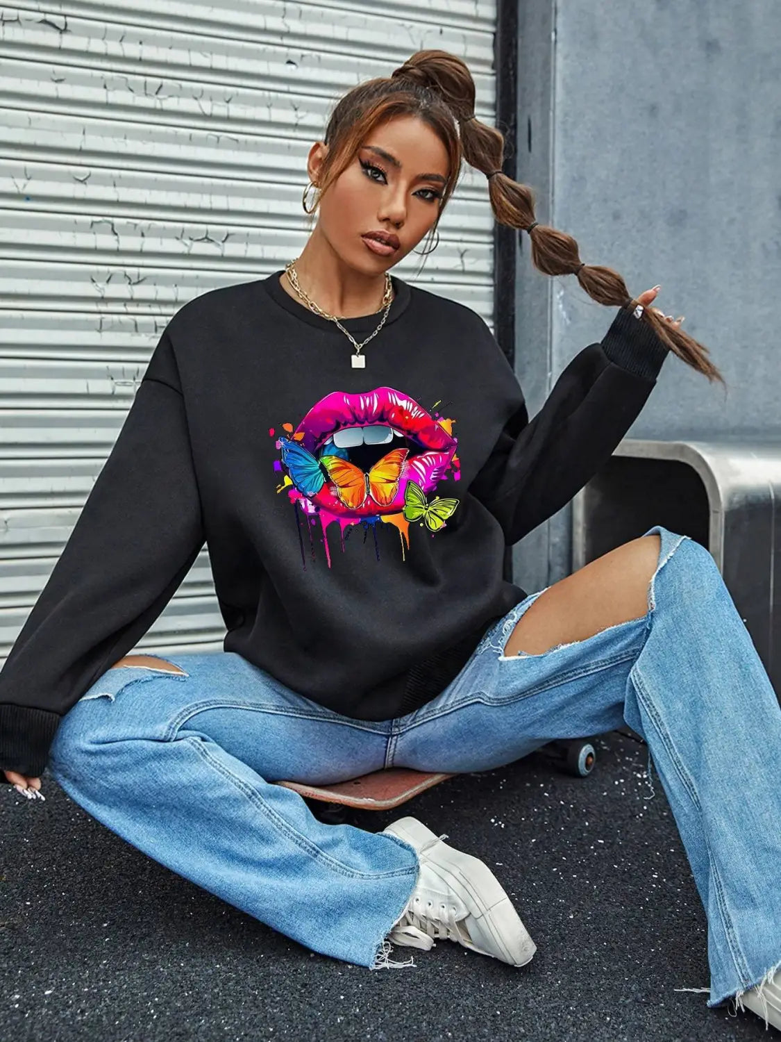 black crew neck sweatshirt featuring vibrant dripping pink and purple lips graphic adorned with colorful butterflies in a white butterfly lips graphic crew neck sweatshirt design