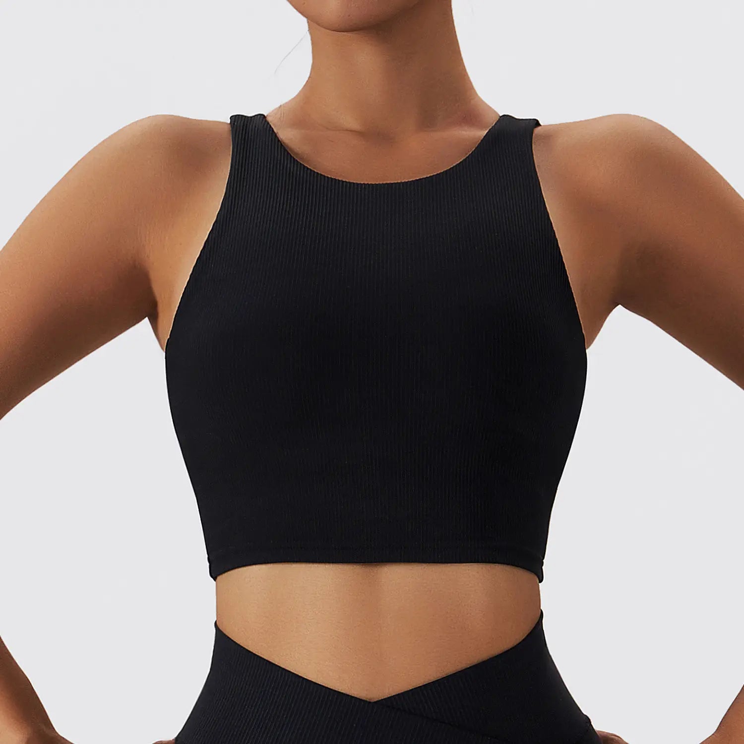 Black ribbed quick dry breathable running sports bra with a high neckline and shoulder straps for running sports activities.