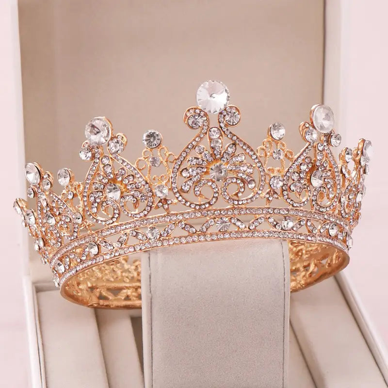 A sparkling rose gold rhinestone big european princess crown hair tiara adorned with intricate filigree and numerous clear crystals.