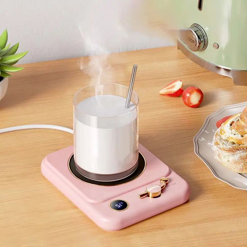 pink electric milk heating insulation base with a digital display showing 51 degrees and gold-colored control knobs designed for desktop use