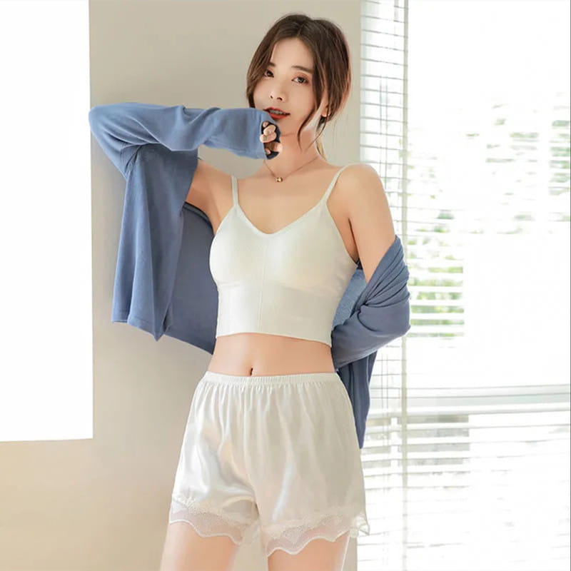 White sheer lace-trimmed pajama shorts made of pink ice silk seamless fabric featuring delicate silk seamless outer lace trim.