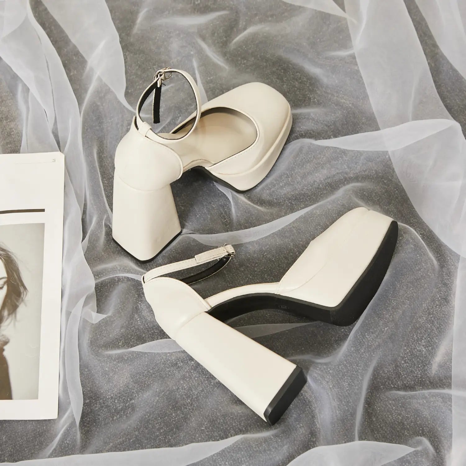 Cream-colored patent leather super high heel platform Mary Janes with black sole and ankle strap