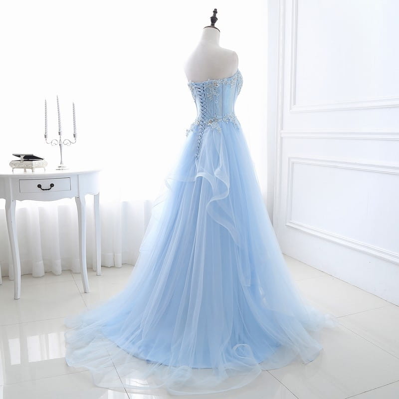 A delicate light blue strapless slim fit bridesmaid gown with intricate lace detailing, silver beading, and a flowing tulle skirt ideal for an annual meeting.