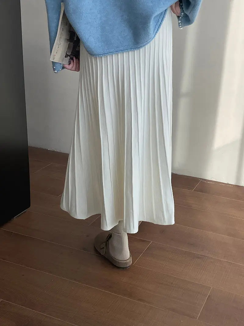 a flowing white pleated midi skirt made from soft lightweight fabric featuring a korean elastic waist knitted design.