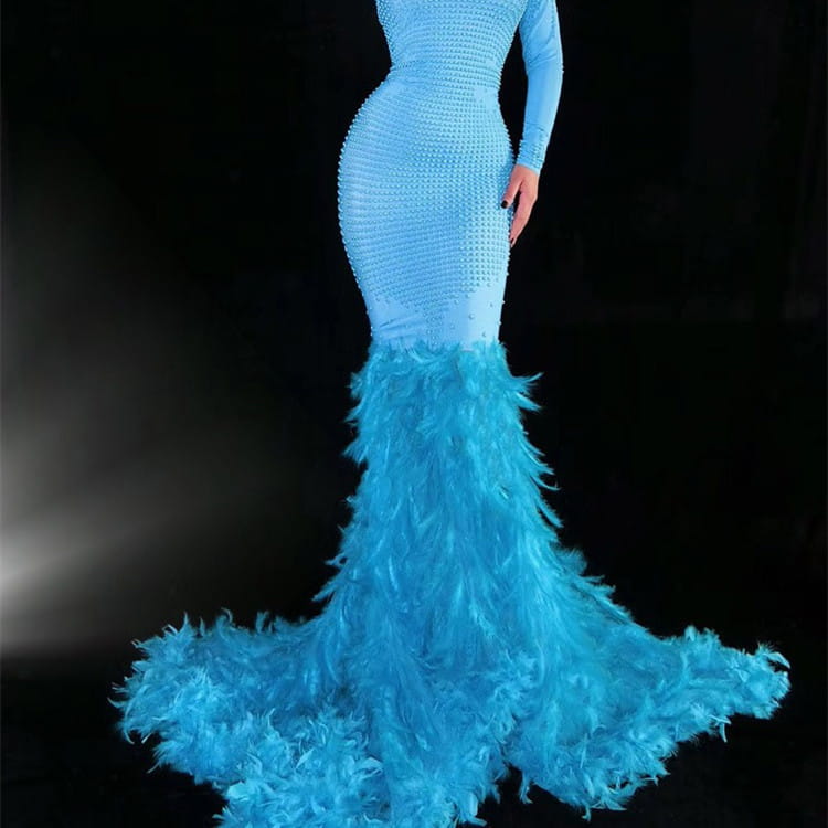 A striking light blue water bottle feather mermaid gown with a fitted bodice adorned with sparkling embellishments and a voluminous feather trailing hip train.