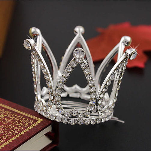 A sparkling silver childrens hair comb crown adorned with clear rhinestones featuring a classic crown design as comb crown rhinestone accessories.