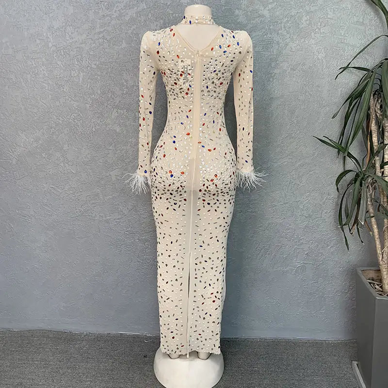 a long-sleeved cream-colored bodycon american slim dress featuring colorful sequins and feathered cuffs made with rhinestone mesh stretch material.