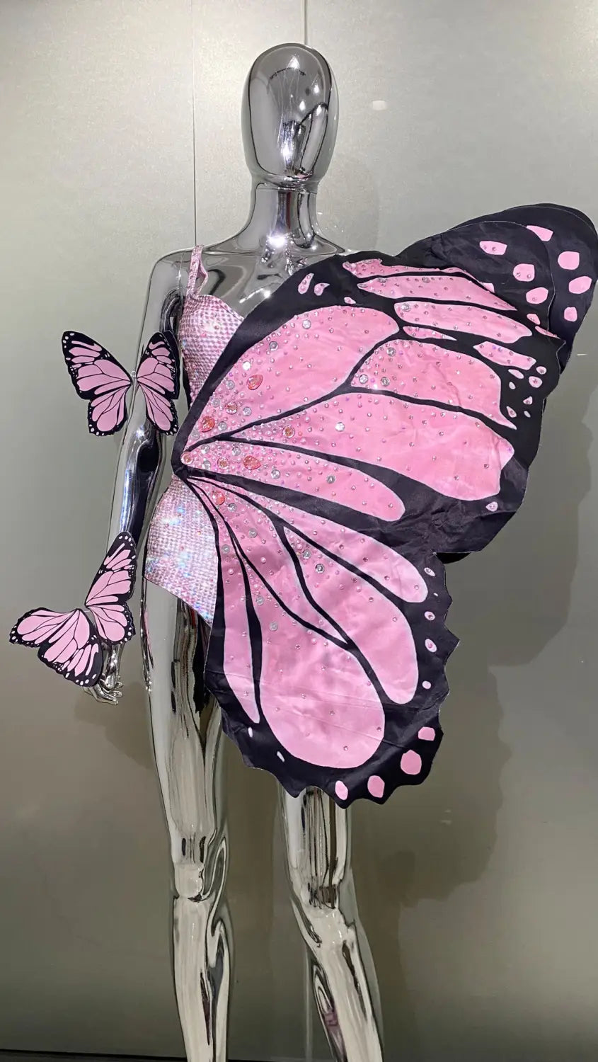 Pink and black glittery sequin butterfly latin dance skirt dress wings displayed on a silver mannequin featuring net yarn stretch material.