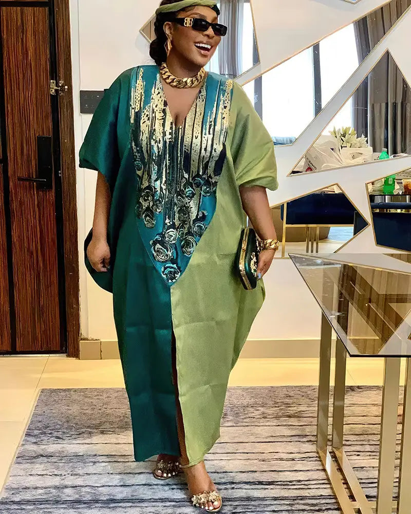Vibrant green and teal two-toned dashiki-style plus size ethnic dress with intricate gold embroidery along the neckline.