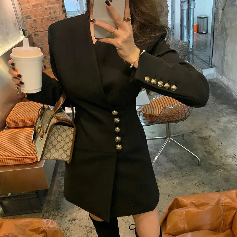 Black blazer dress in lightly cooked style featuring gold buttons and a tailored fit for cooked style ladies.