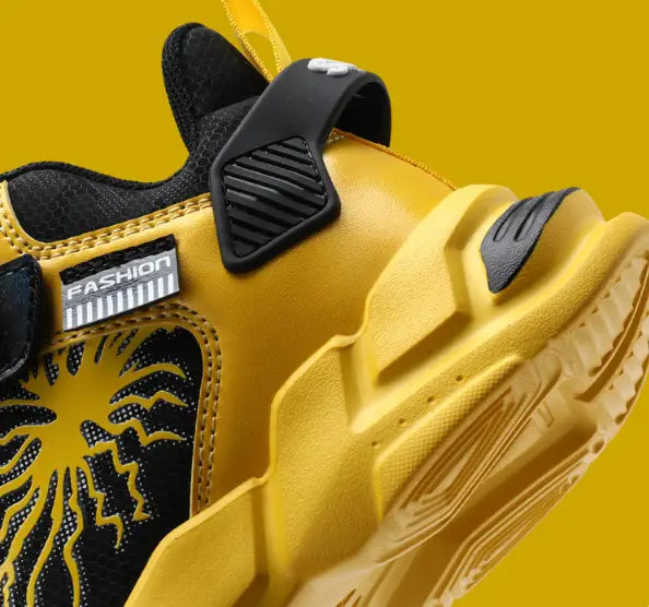 Vibrant yellow and black winter cotton shoes with waterproof leather uppers featuring a bold stylized sunburst design on the side panel.